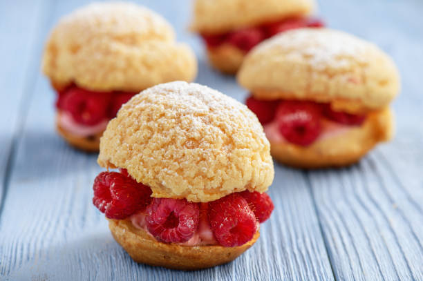 istock Eclairs with mascarpone cream and raspberries. 804649254