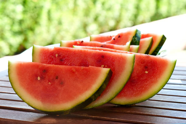 istock Watermelon slices on a wooden background 5 804665512