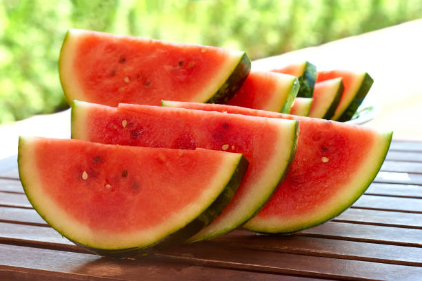 istock Watermelon slices on a wooden background 6 804665518