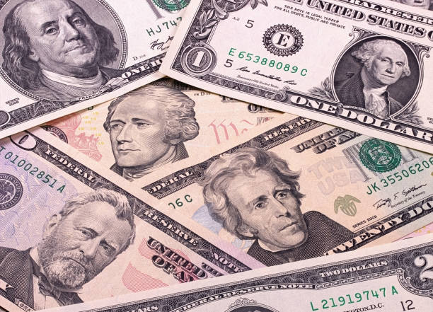 istock Abstract dollar bills of different denominations background. 804668638