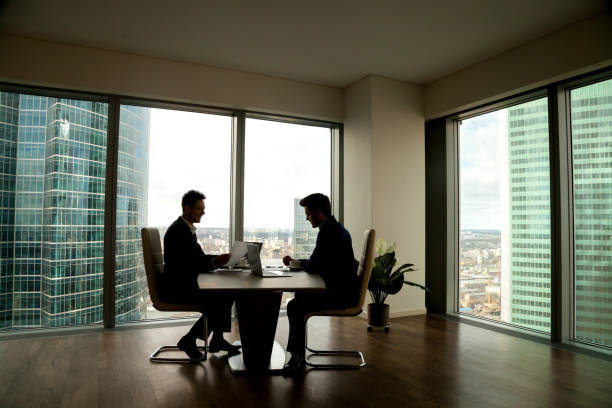 istock Two businessmen negotiating sitting at conference table in modern office 804671346