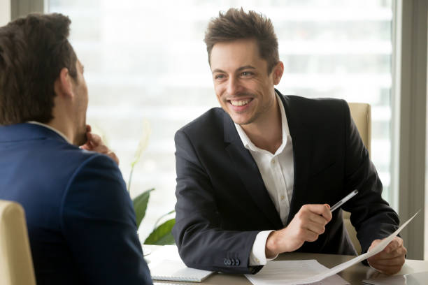 istock Two smiling positive businessmen laughing, having fun during business discussion 804671448