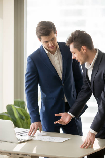 istock Two appraisers working on architectural project with laptop, building plan 804671688
