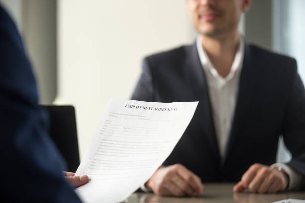istock Job applicant holding employment agreement, considering work terms, position duties 804671754