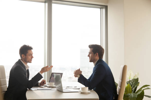 istock Business meeting of two partners talking and working on laptops 804671834