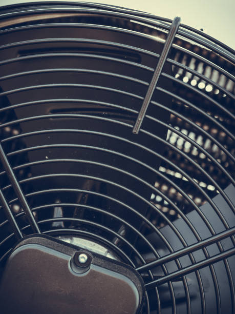 istock Closeup of black fan on white machine 804674654