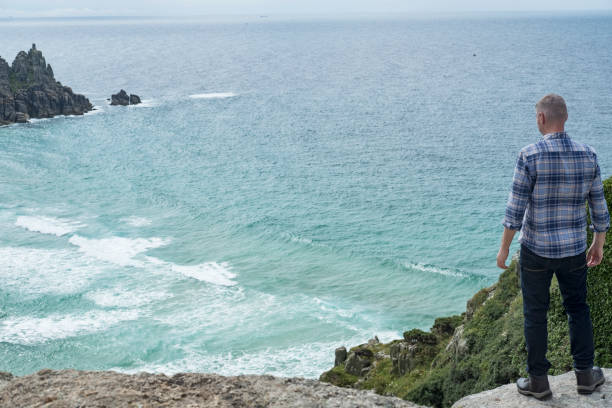 istock Man stood on cliffs above Pedn Vounder Beach, South Cornwall. 804684918