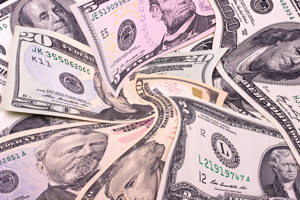 istock Abstract dollar bills of different denominations background. 804685466