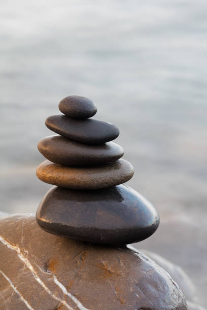 istock Stones pyramid on pebble beach symbolizing stability, harmony, balance. Shallow depth of field. 804689958