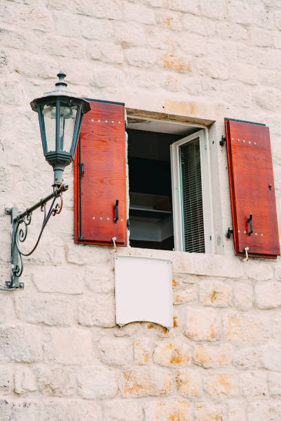 istock Vintage lamp on the wall on street 804690398