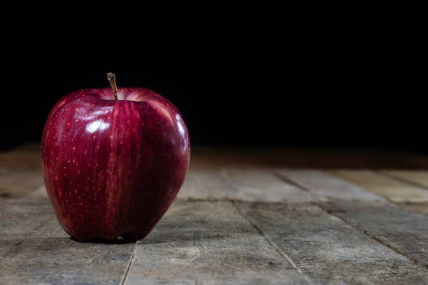 istock Red tasty wet apple on a wooden table 804698274