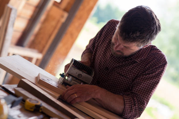 istock Male Carpenter working on planks 804699040