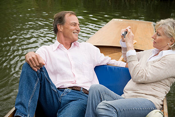Mature couple photographing on a boat  couple punting stock pictures, royalty-free photos & images