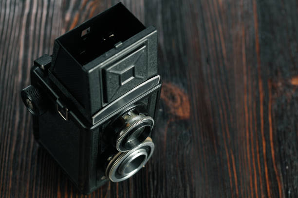 istock The old film camera on the old wooden table. 804701318
