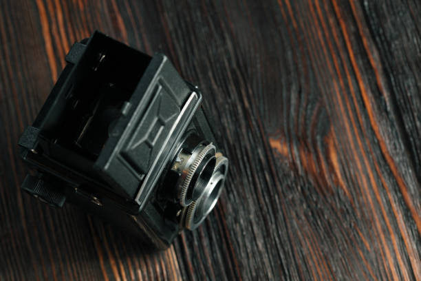 istock The old film camera on the old wooden table. 804701406