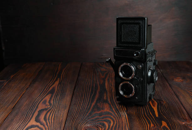istock The old film camera on the wooden table. 804701446
