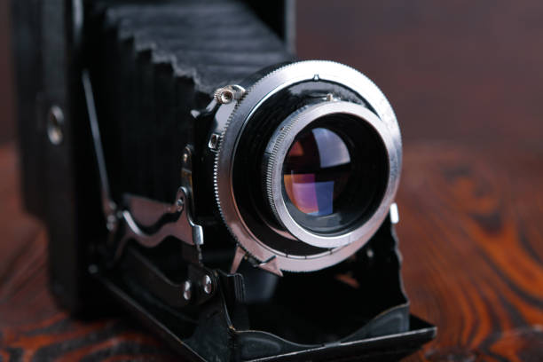 istock The old film camera on wooden table. 804701498