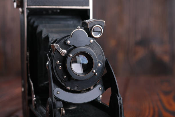 istock The old film camera on wooden table. 804701518