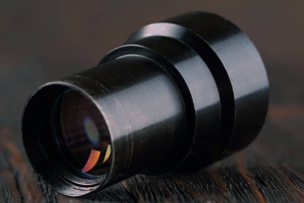 istock Old lens from old camera on the wooden table 804701566