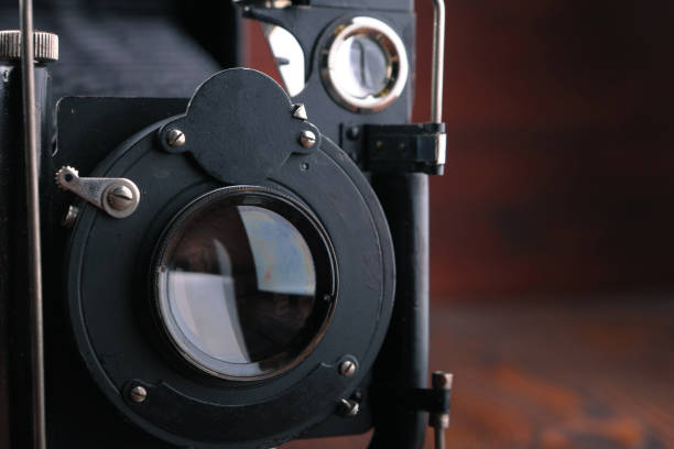 istock The old film camera on wooden table. 804701612