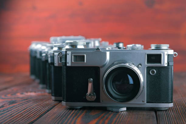 istock The old film camera on wooden table. 804701886