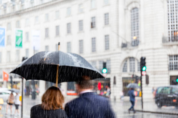 Blurred couple walking in rain at Regent Street Lodon