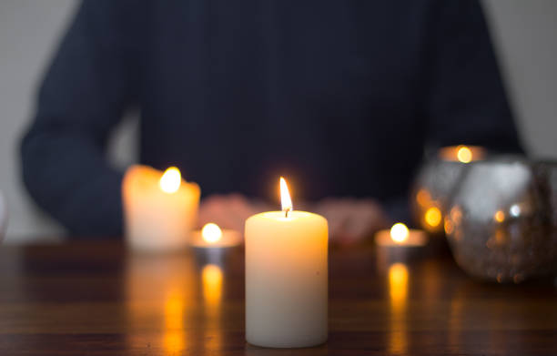 istock sitting man and candles on the table 804705206