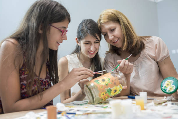 Art workshop Teenage girls working in creative art decoupage workshop with tutor decoupage stock pictures, royalty-free photos & images