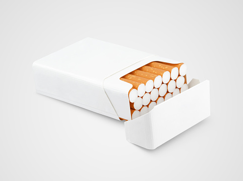 Opened pack of cigarettes lying on gray background with clipping path