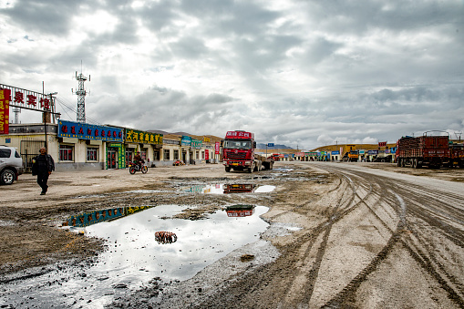 Qinghai, China - September 18th, 2015 : trucks parked  in a roadside village in Qinghai China