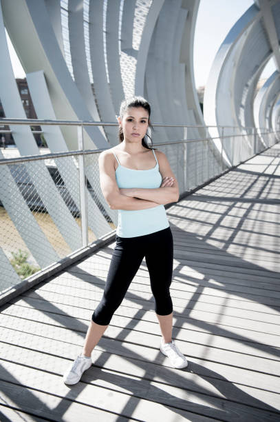 istock attractive hispanic brunette woman looking cool and defiant after running workout 804768682