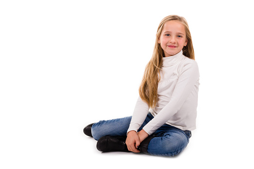 Portrait of a pretty young girl with long blonde hair isolated on a white background