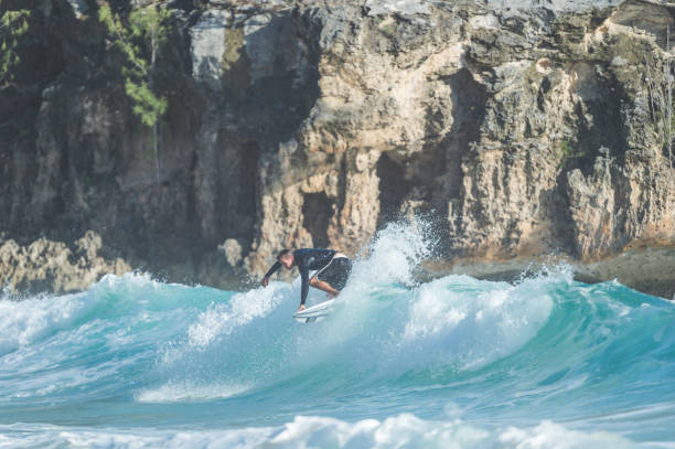 istock Young Caucasian surfer rides a wave into shore 804791198