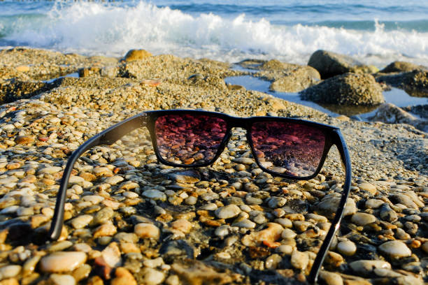 istock Black sunglasses at sea background 804793568