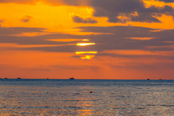 istock Dark clouds and sun over the sea at sunset 804793784