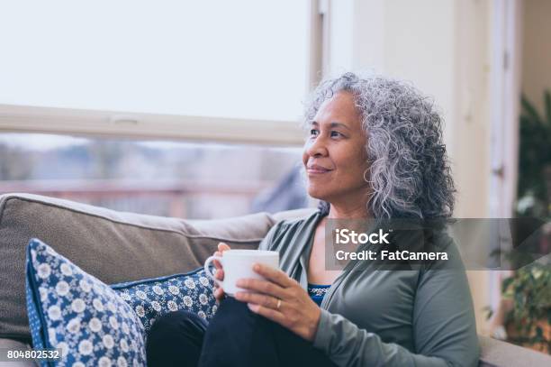 Hawaiian Woman Doing Yoga Pose Inside In Morning Stock Photo - Download Image Now - Mature Women, Lifestyles, Mindfulness