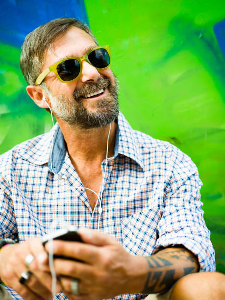 Portrait of mature man, graffiti on background
