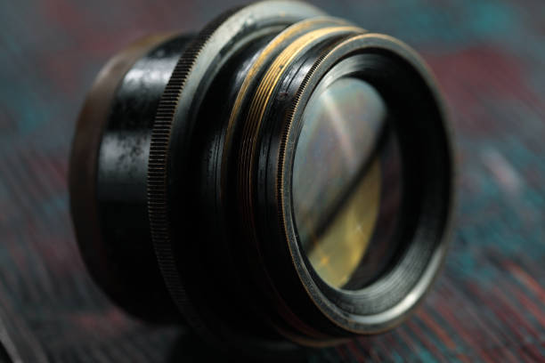 istock Old lens from old camera on the wooden table 804820018