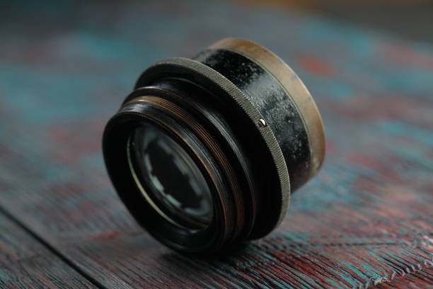 istock Old lens from old camera on the wooden table 804820020