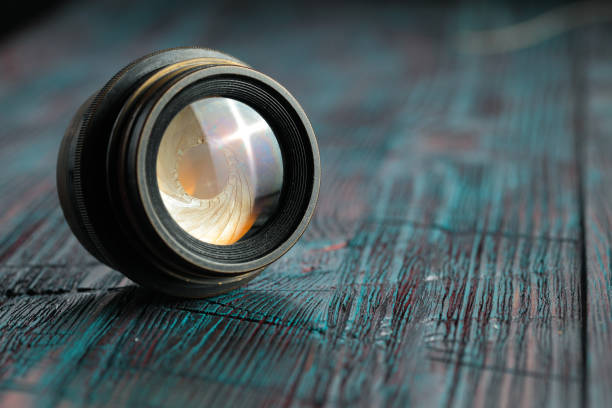 istock Old lens from old camera on the wooden table 804820022