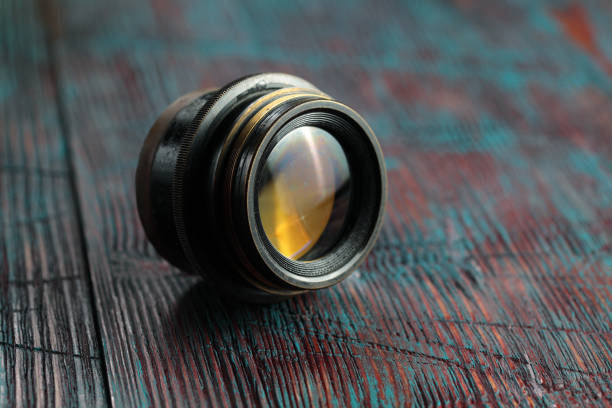 istock Old lens from old camera on the wooden table 804820028