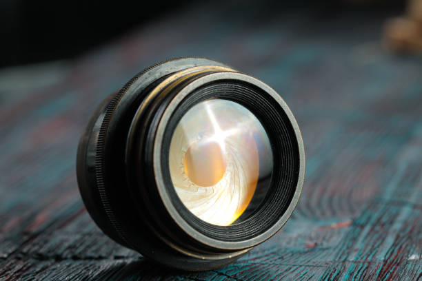 istock Old lens from old camera on the wooden table 804820030
