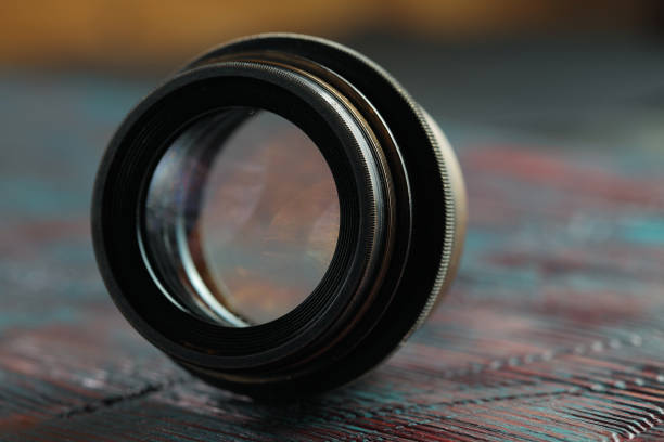 istock Old lens from old camera on the wooden table 804820046