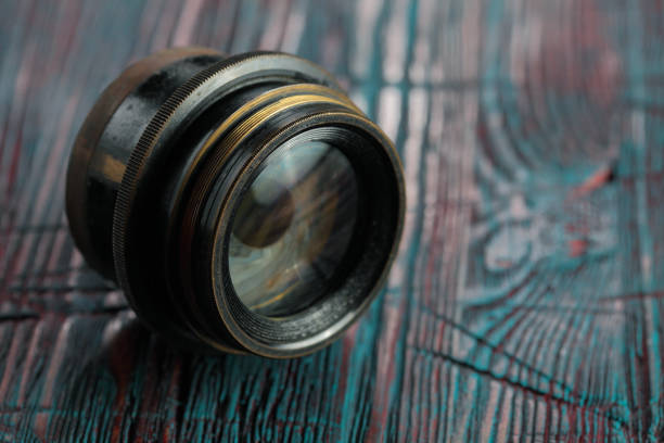 istock Old lens from old camera on the wooden table 804820048
