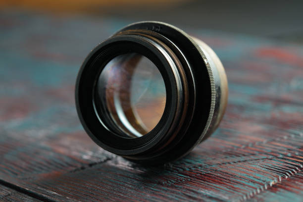 istock Old lens from old camera on the wooden table 804820050