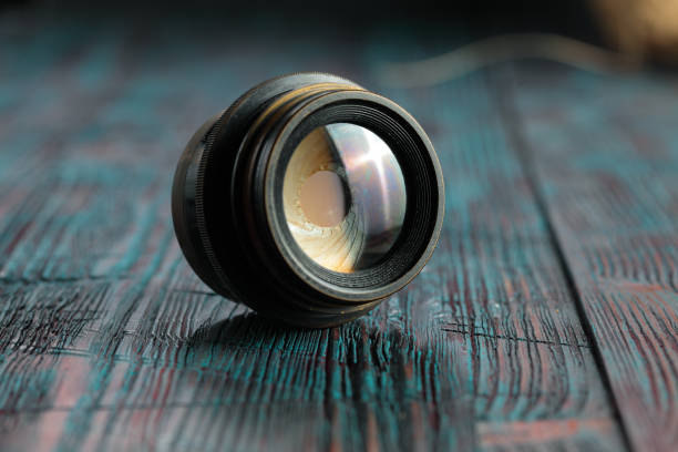 istock Old lens from old camera on the wooden table 804820068
