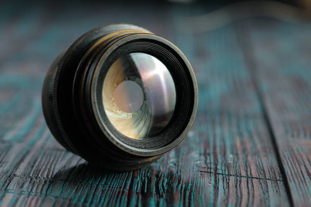 istock Old lens from old camera on the wooden table 804820108