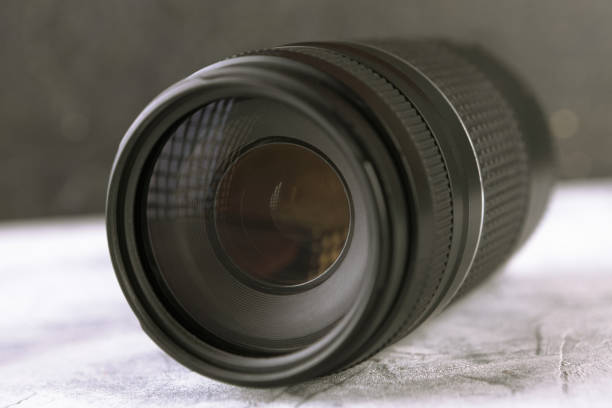 istock Lens for a SLR camera on a gray cement background. 804820120