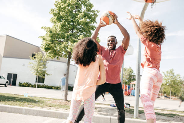 istock Father playing basketball with daughters 804827222
