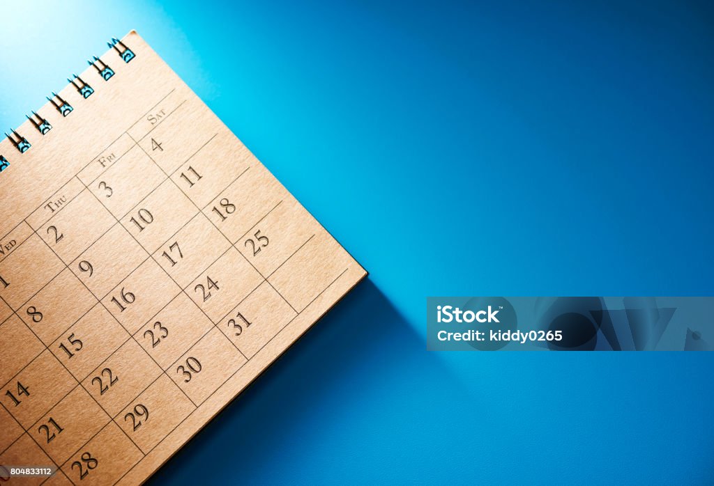 Deadline. Office supply on blue background with copy space.Work tools on desk table. Shot with top view. Calendar Stock Photo